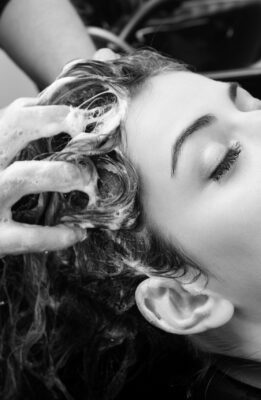 Beautiful woman washing her hair in hairsalon